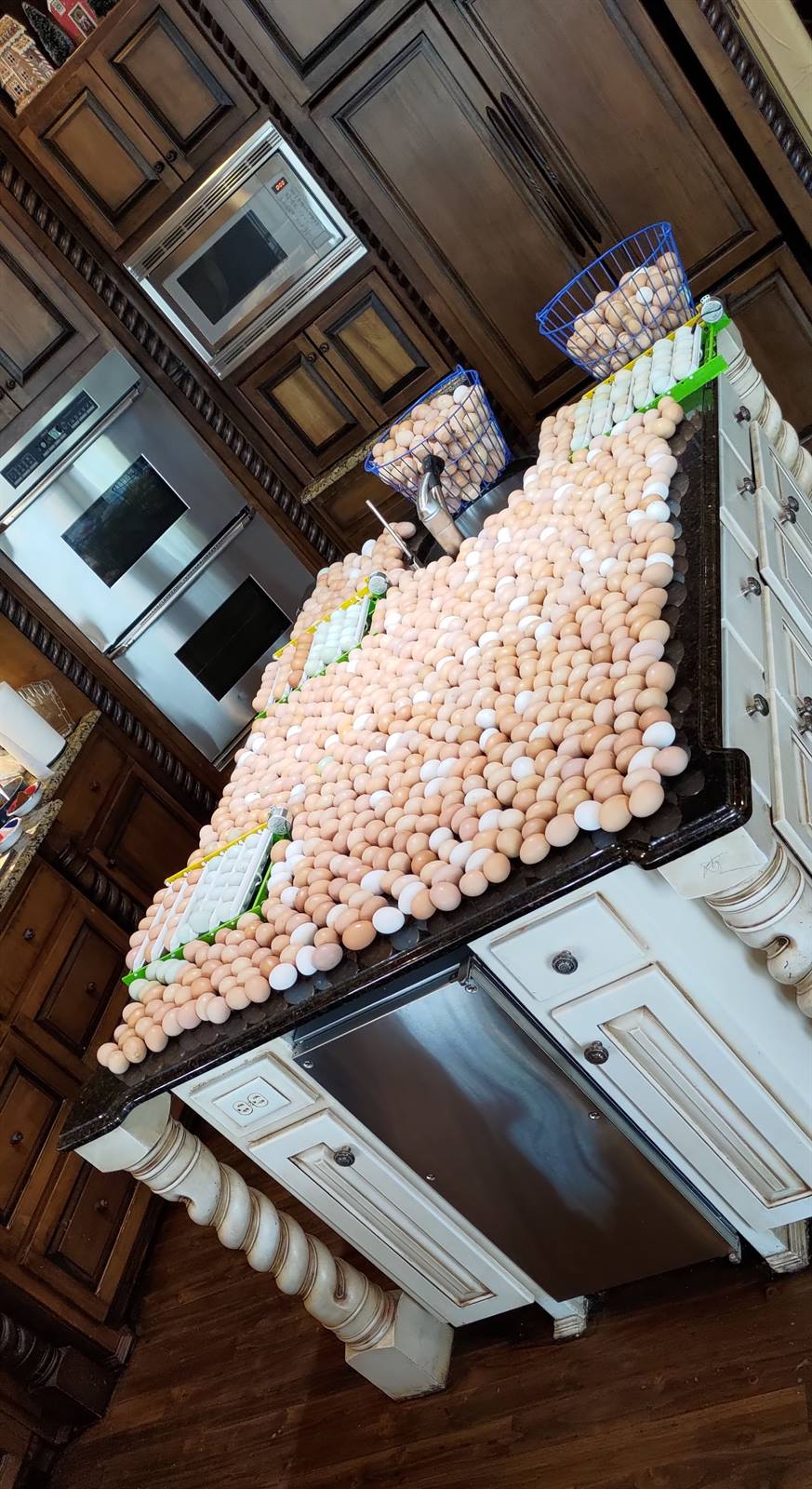 A kitchen island completely covered in fresh eggs
